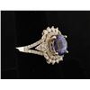 Image 2 : 14K ring set with approx. 3.16 carats  Tanzanites surrounded by 1.03 carats