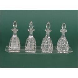 Gewürzset. Rechteckige Glasschale mit vier Kristallflakons. Deutsch nach 1900....