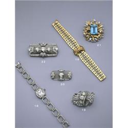 A DIAMOND BROOCH/BRACELET CA 1935, The central plaque of openwork scroll design set to the center...