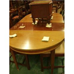 Oval extending dining table with two leaves in mahogany with round tapering legs and ormolu decor…