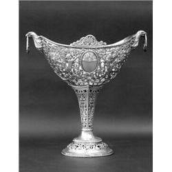 CONTINENTAL SILVER FRUIT STAND, German. Circa 1890. (.800 fine) The pierced oval bowl with scro...