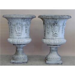 PAIR OF CAST STONE URNS, Each of campana form with bellflower and shield design. Height 34 1/4"...