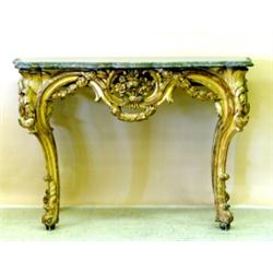 LOUIS XV CARVED AND GILTWOOD CONSOLE TABLE, French. 18th Century. The serpentine fronted marble...