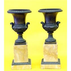 PAIR OF CHARLES X PATINATED BRONZE AND MARBLE URNS, French. Circa 1830. Each with beaded and ga...