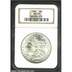 1880 $1 MS65 NGC. Shimmering cartwheel luster dominates the brilliant, snow-white surfaces. Well...