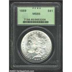 1889 $1 MS65 PCGS. Boldly struck and fully lustrous, with flashy semi-prooflike surfaces. There a...