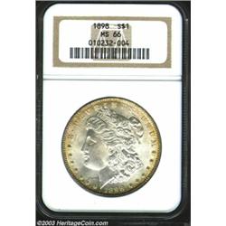 1898 $1 MS66 NGC. A fully original Gem example exhibiting a pretty peripheral ring of golden colo...
