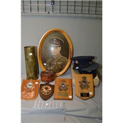 A selection of military collectibles including framed print, hats, shell case, collar box, hats etc.