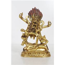 [CHINESE] A LATE 19TH CENTURY SINO-TIBETAN GILT-BRONZE FIGURE Depicting a bull-headed deity dancing 