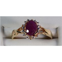 10 K YELLOW GOLD LAB CREATED RUBY AND DIAMOND RING. OVAL SHAPED CENTER STONE