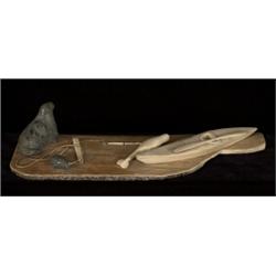 Inuit Carved Kayak and Seal Scene on Whale Bone Base Signed UNK 14 3/4" L. 5 1/4" W. Fine Condit…