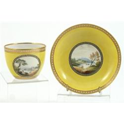 A Derby yellow ground porcelain teacup and saucer, circa 1790, enamelled with circular scenes of...