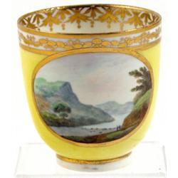 A Derby yellow ground coffee cup, circa 1795, enamelled with an oval gilt bordered landscape, pro...