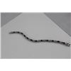Image 2 : 6CT OVAL GARNET AND DIAMOND TENNIS BRACELET. 12 OVAL GARNETS. INCLUDES $550 CERTIFICATE