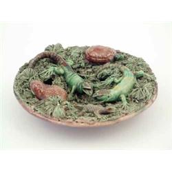 An early 20th century Portuguese Palissy style tin glaze earthenware plate, applied with lizards...