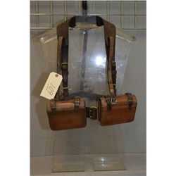 Ant Leather Shoulder Harness w/ two pouches, displayed on small plastic display