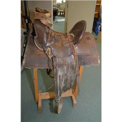 Antique Western Saddle w/hi back, needs restoration, c/w wood stand