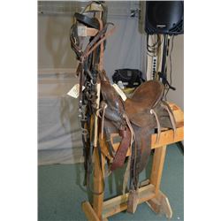 Universal 1902 Pattern Antique Saddle, numrahs good, c/w 2 bridles & wooden stand