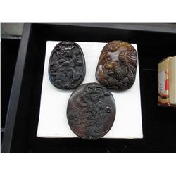 3 Carved stone pendants
