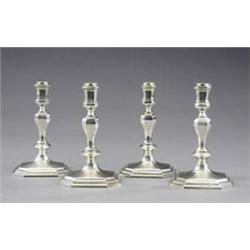 A set of four cast candlesticks,...