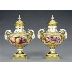 A pair of Royal Worcester urn shape vases and covers,...