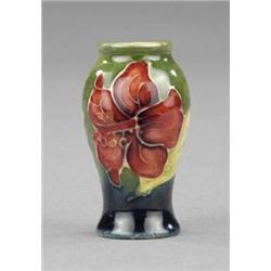 A Moorcroft Hibiscus pattern miniature baluster vase,...
