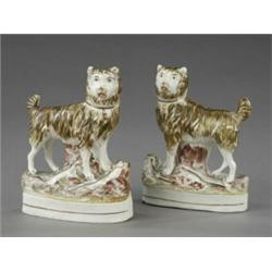 An unusual pair of Victorian Staffordshire figures of terriers ratting,...