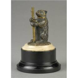 A late 19th century gilt and bronzed metal figure of a seated bear,...