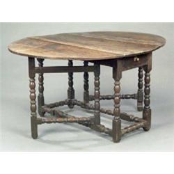 An early 18th century oak oval gateleg dining table,...