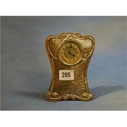 An Edwardian bedroom timepiece contained in a planished silver easel case Birmingham 1906 £50-75...