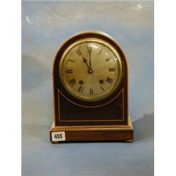 An Edwardian 8 day striking bracket clock with silver dial and Roman numerals contained in an arc...