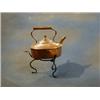 A 19th Century copper kettle raised on an iron stand £10-20...