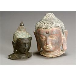 Two Southeast Asian Heads of the Buddha The first, a Thai red and black lacquered composition,...