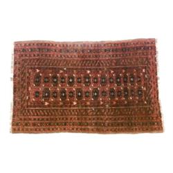 Turkoman Rug Circa 1950 Red ground with two vertical rows of star medallions on red ground...