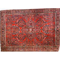 Sarouk Rug Second Quarter 20th Century Red ground with floral spray field within a rosette...