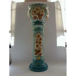 A BURMANTOFTS FAIENCE JARDINIERE AND STAND, late 19th Century, moulded sunflower within turquoise...