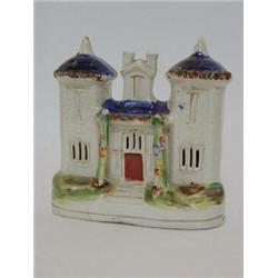 A STAFFORDSHIRE FLATBACK CHIMNEY ORNAMENT, mid 19th Century, formed as a Regency twin tower cotta...