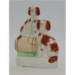 A STAFFORDSHIRE FLATBACK FIGURE GROUP, 19th Century, a pair of seated brown and white spaniels, o...