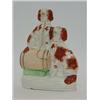Image 1 : A STAFFORDSHIRE FLATBACK FIGURE GROUP, 19th Century, a pair of seated brown and white spaniels, o...