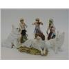 Image 1 : A TINTED BISQUE LYING DOG FIGURE, c.1900, two in plain white and three bisque monkey band figures...
