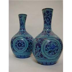 A PAIR OF FAIENCE BOTTLE VASES, (probably North Indian, c.1900) turquoise ground, Isnik decoratio...