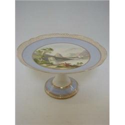 A DESSERT COMPORT, mid 19th Century, on high trumpet base, painted lake scene reserved by pastel...