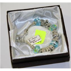 SILVER CHARM BRACELET WITH BLUE STONES AND CHARMS