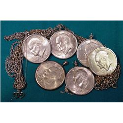 (6) Eisenhower Dollars in Bezels, some chains, and possibly a couple of small diamonds in a pendant.