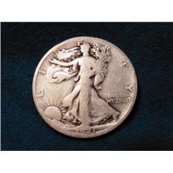 1921 S Walking Liberty Half Dollar. Dark toning stripes on reverse. Good. Red Book value $48.00.