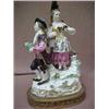 Image 2 : Meissen double figural lamp, man holding bottle, and woman with basket and grapes, on oval brass...