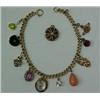 Image 1 : Gold charm bracelet, 10K gold link bracelet measuring 7 1/8" wide, ten charms made from stick-pin...