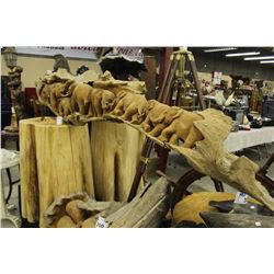 LARGE INTRICATE CARVING OF A HERD OF WALKING ELEPHANTS, CARVED OUT OF THE TRUNK OF A TEAK TREE,