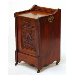 Edwardian carved walnut Perdonium with pull down front, brass handles and china castors…