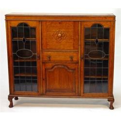 1920s oak bureau bookcase, fitted a centre fall above a drawer and fielded panel door, flanked by…